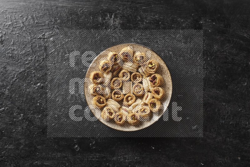 Oriental sweets in pottery plates in a dark setup