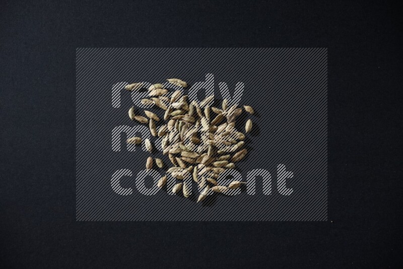 Cardamom seeds on black flooring
