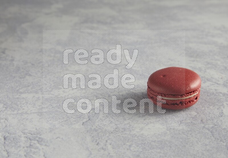 45º Shot of Red Velvet macaron on white  marble background