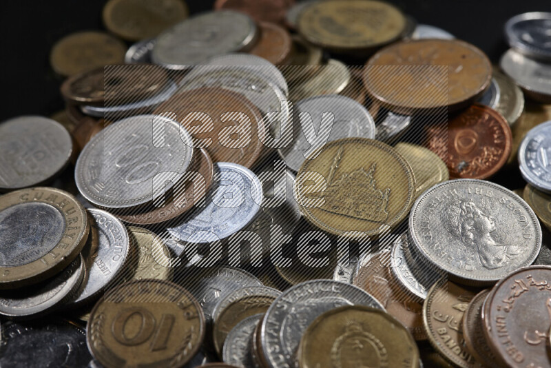 A close-ups of random old coins on black background