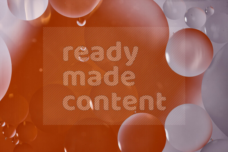 Close-ups of abstract oil bubbles on water surface in shades of white and orange