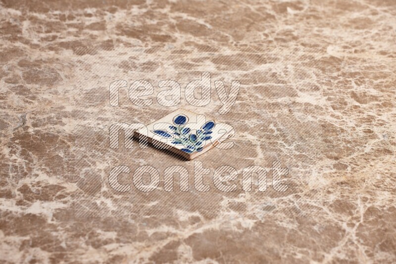 A decorative coaster on beige marble background