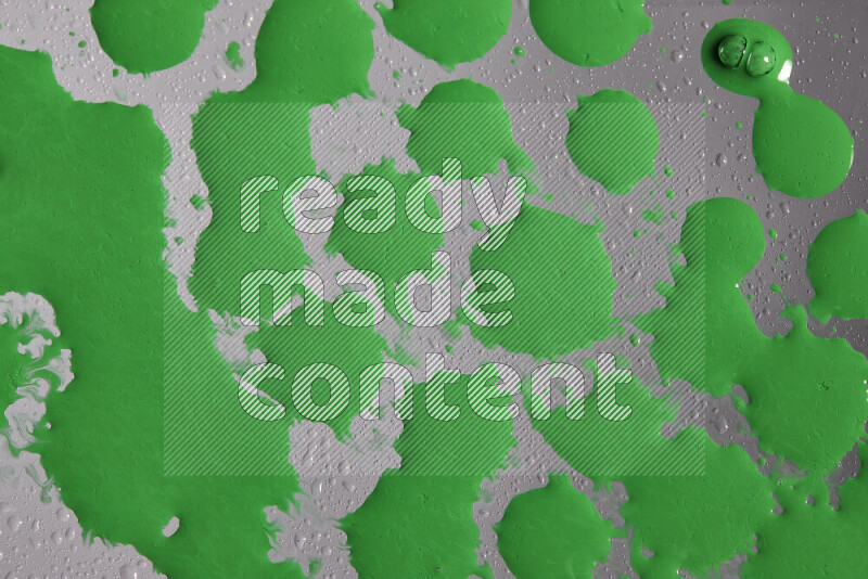 Close-ups of abstract green paint droplets on the surface