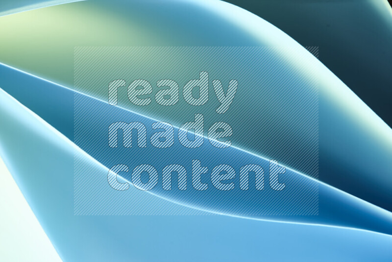This image showcases an abstract paper art composition with paper curves in green and blue gradients created by colored light