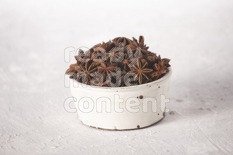 Star Anise in a white bowl on white background