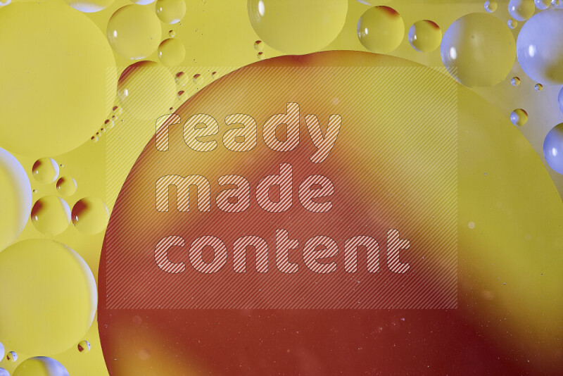 Close-ups of abstract oil bubbles on water surface in shades of orange and yellow