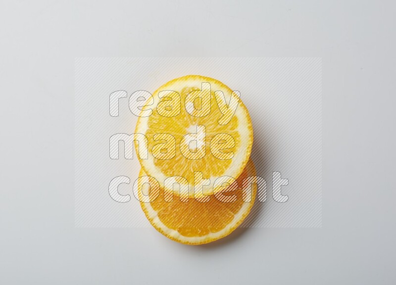 Two orange slices on white background