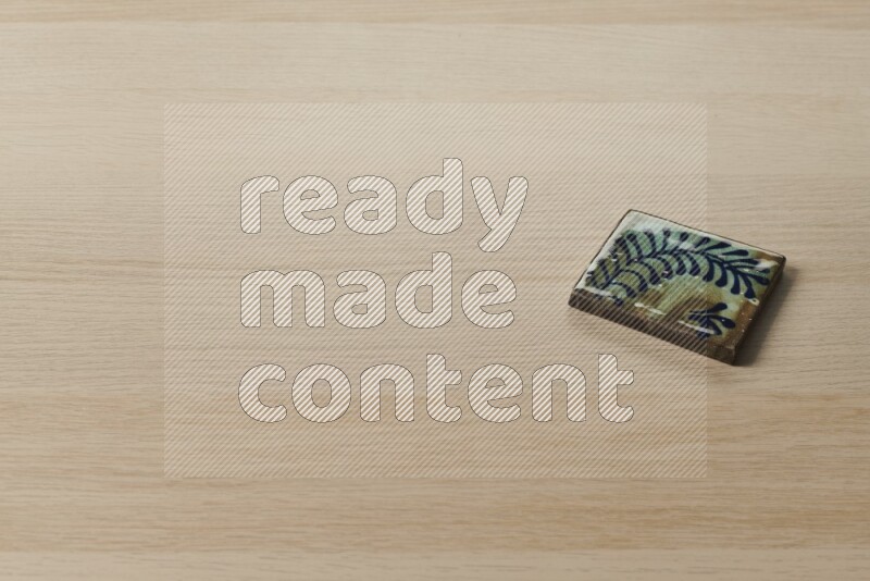 A decorative coaster on light wooden background