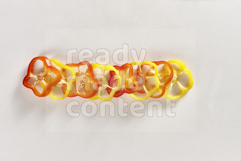 Assorted bell pepper slices on white background
