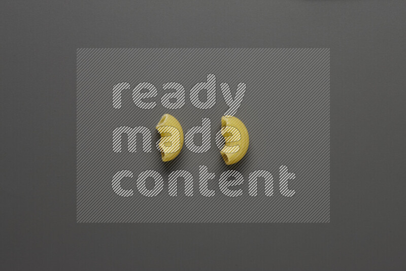 Elbow pasta on grey background