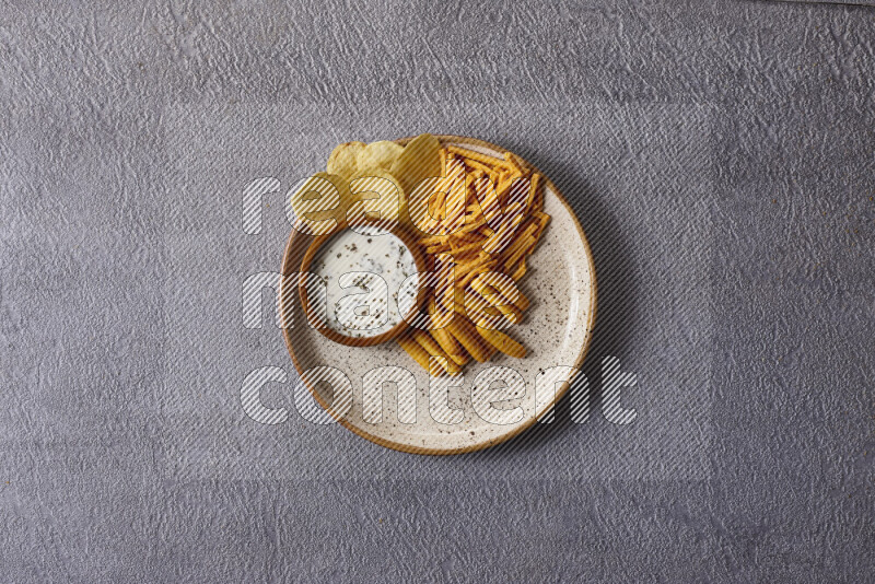 Assorted snacks in pottery bowls on grey background