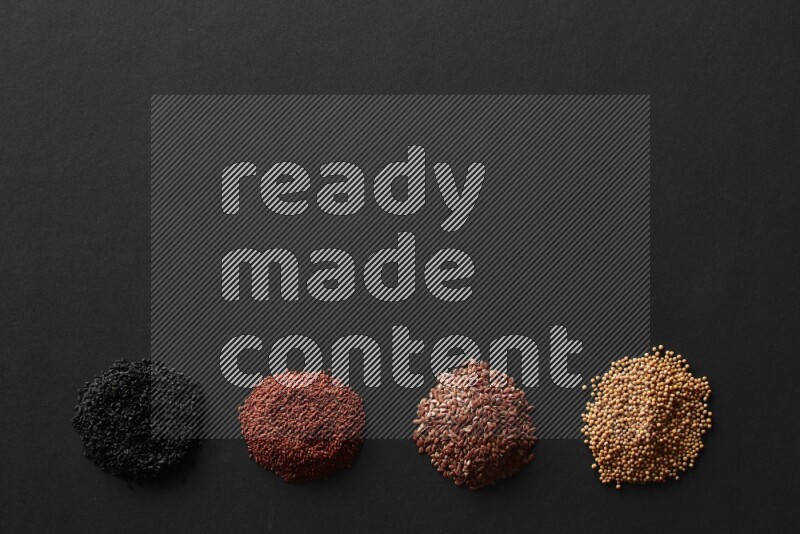 Black seeds, mustard seeds, garden cress and flax on a Black background