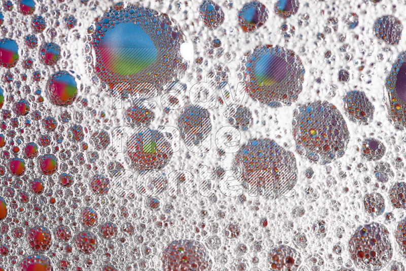 Close-ups of abstract soap bubbles and water droplets on multicolored background