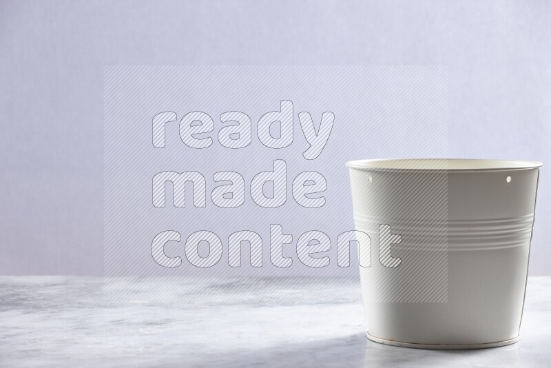 An empty white plant pot on grey marble background