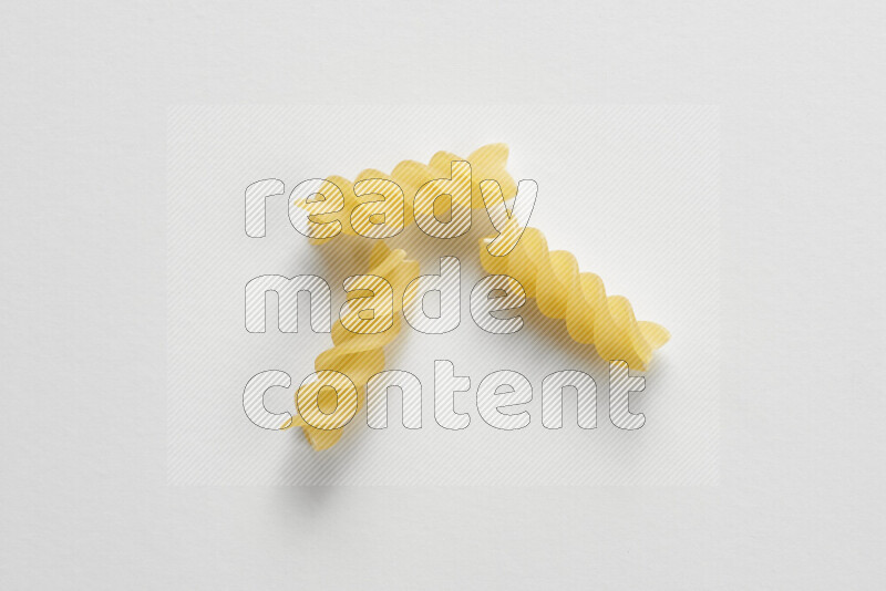 Fusilli pasta on white background