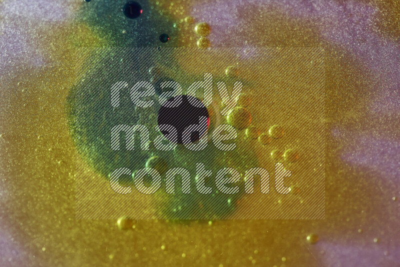 Close-ups of abstract yellow, blue and green watercolor drops on oil Surface on white background