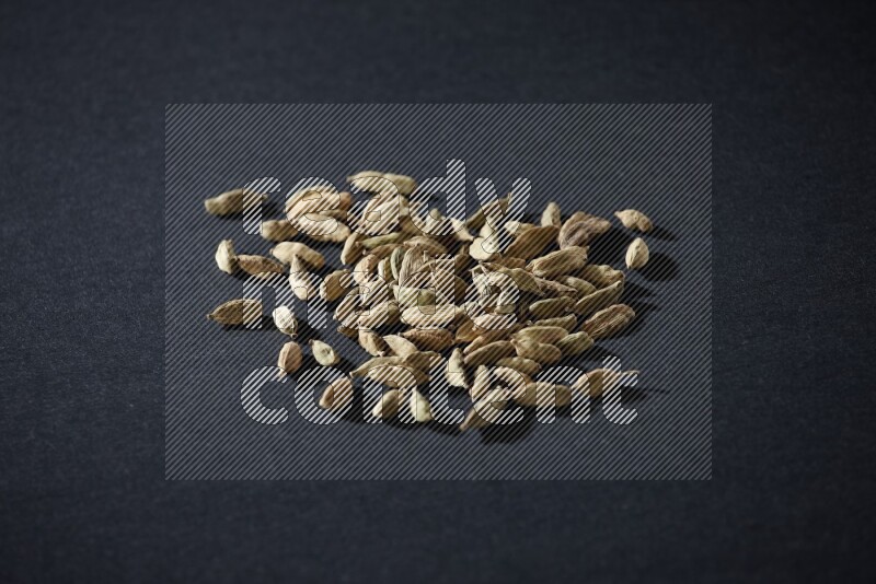 Cardamom seeds on black flooring