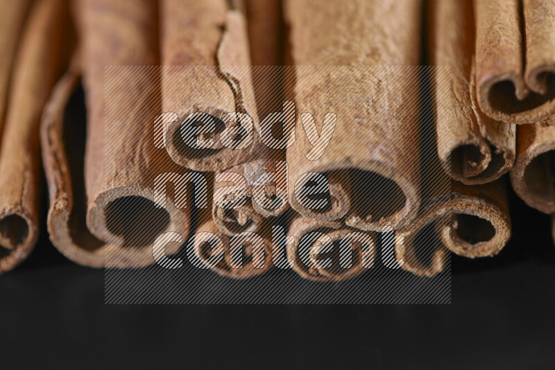 Cinnamon sticks on black background