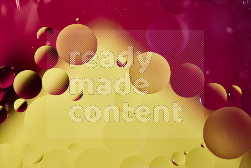 Close-ups of abstract oil bubbles on water surface in shades of red and yellow