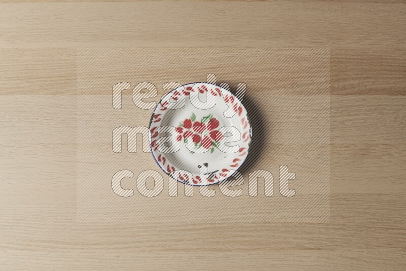 A vintage metal plate on light wooden background