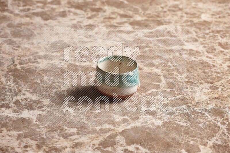 Multicolored Pottery Bowl on Beige Marble Flooring