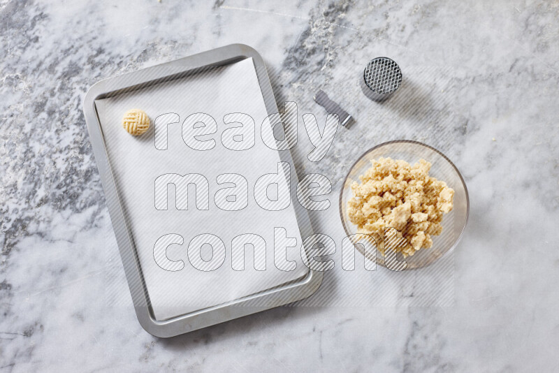 Kahk step by step with its ingredients ghee, sugar, flour, sesame, yeast, water and kahk flavor on grey marble background