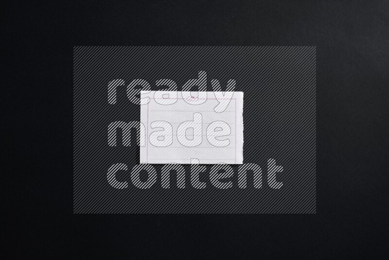 Folded notebook sheet on black background