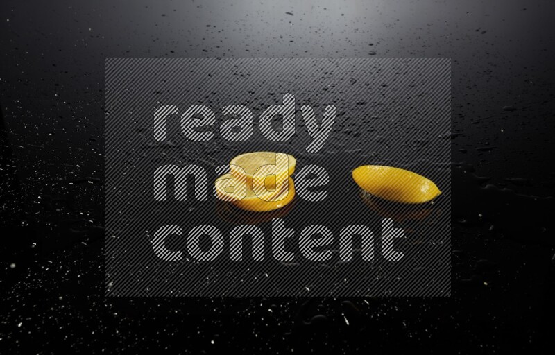 Lemon slices with water drops, and droplets on black background