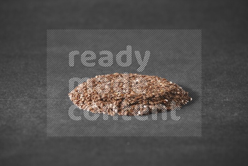 Flax Seeds in a circle shape on a black Flooring