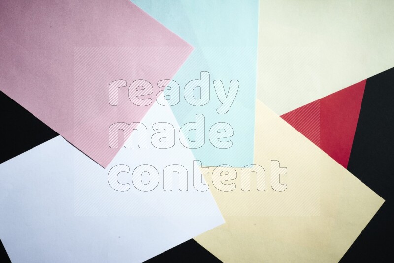 Multicolored paper sheet on black background