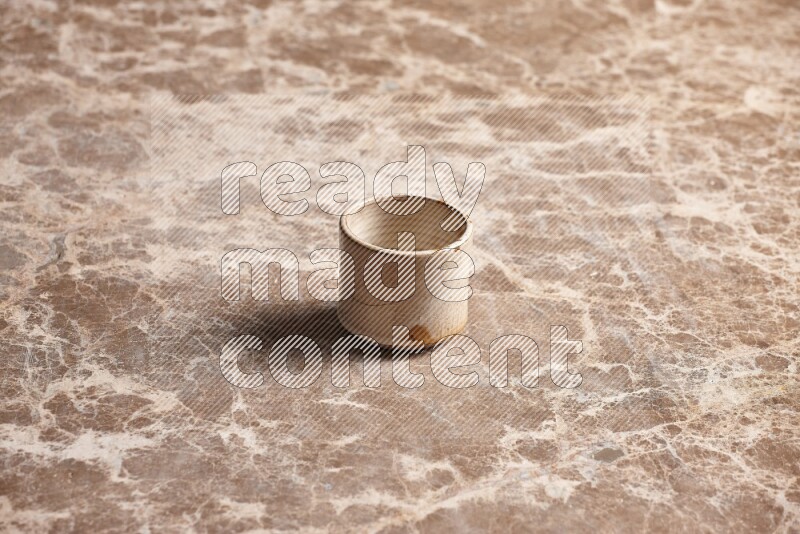 Pottery Cup on Beige Marble Flooring