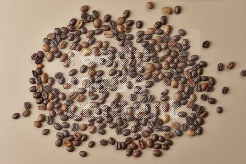 Roasted coffee beans on beige background