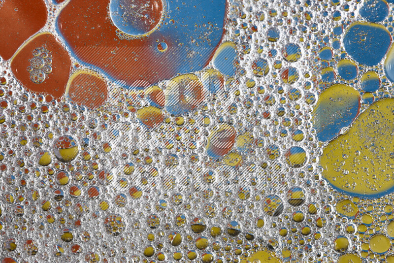 Close-ups of abstract soap bubbles and water droplets on multicolored background