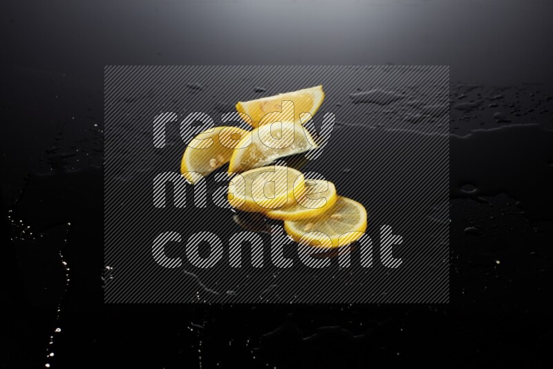 Lemon slices with water drops, and droplets on black background