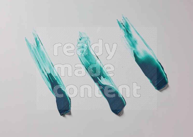 Turquoise painting knife strokes on white background