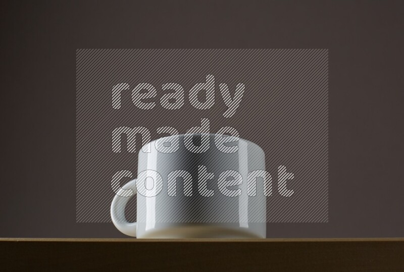 Low angle shot of a white cup on grey background