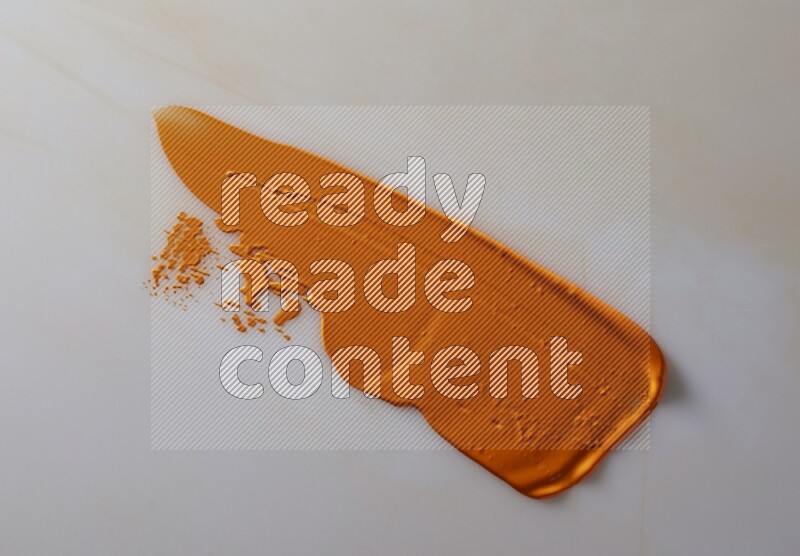 An orange straight painting knife stroke on white background