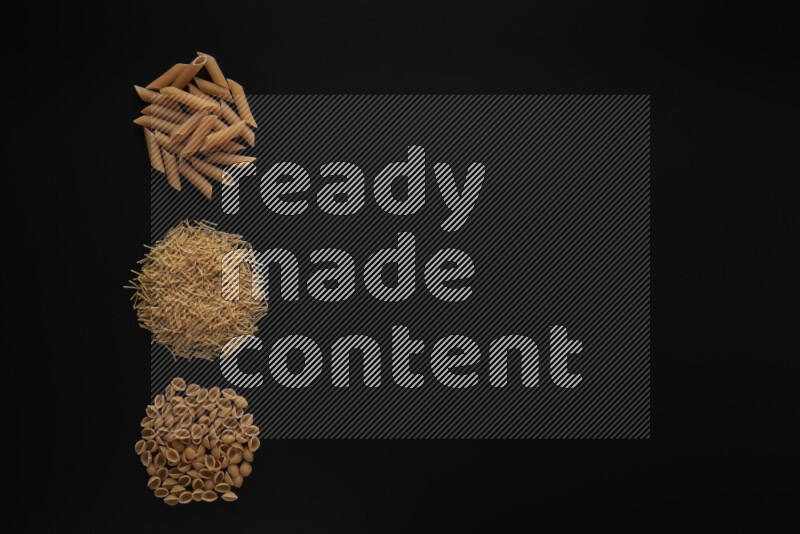 Different pasta types in 3 bunches on black background