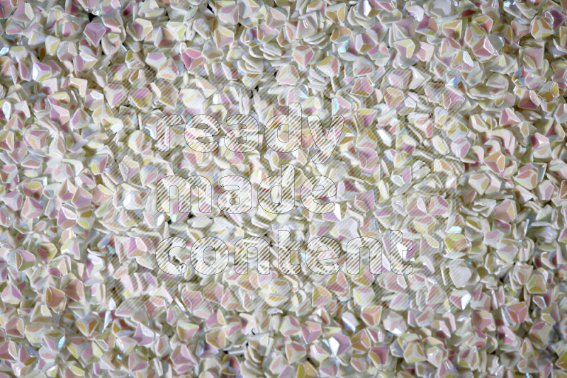 Colorful plastic shards for decoration scattered on a black background