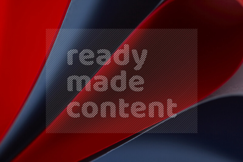 An abstract art showing red and blue paper sheets arranged in an overlapping curves