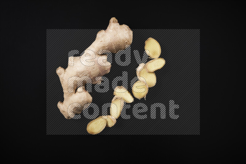 Fresh ginger root on black background