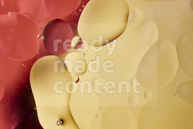 Close-ups of abstract oil bubbles on water surface in shades of red and yellow