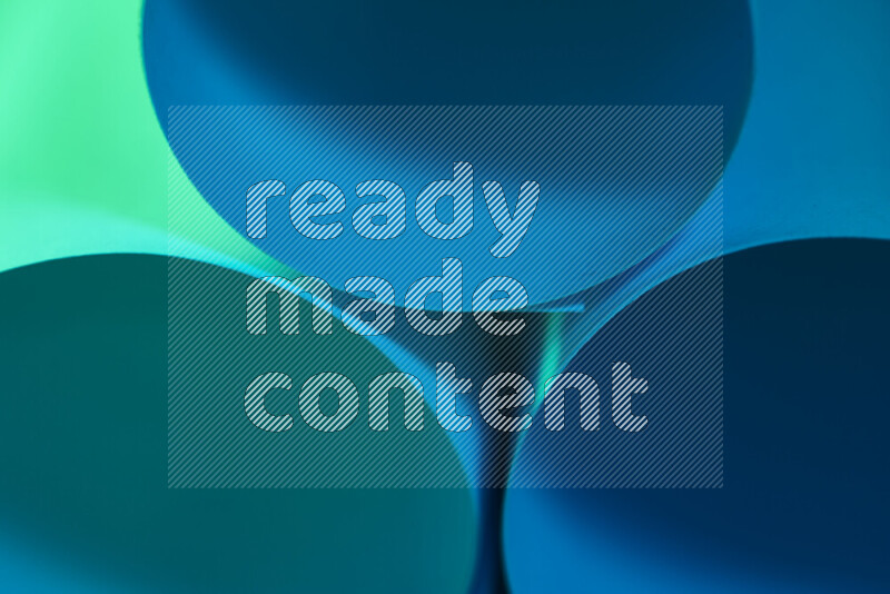 The image shows an abstract paper art with circular shapes in varying shades of green and blue