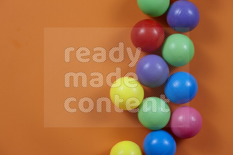 Multicolored plastic balls on different colored backgrounds (kids toys)