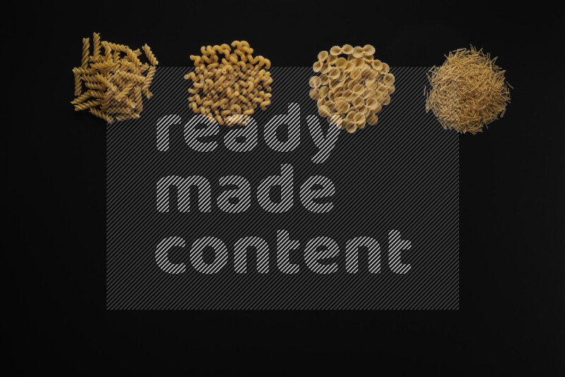 Different pasta types in 4 bunches on black background