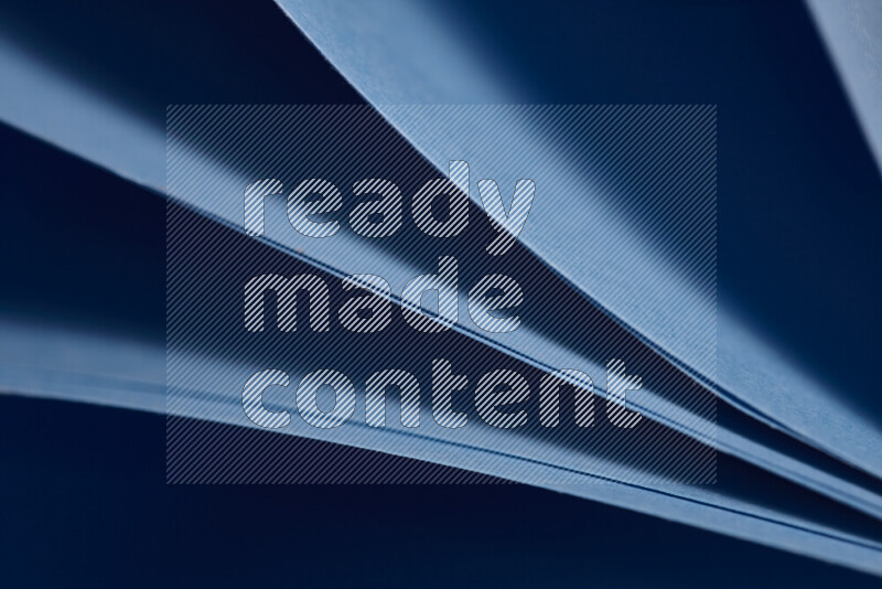 An abstract art showing blue paper sheets arranged in an overlapping curves