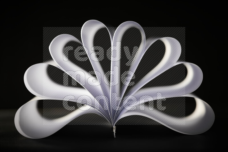 An abstract art piece displaying smooth curves in grey gradients created by colored light