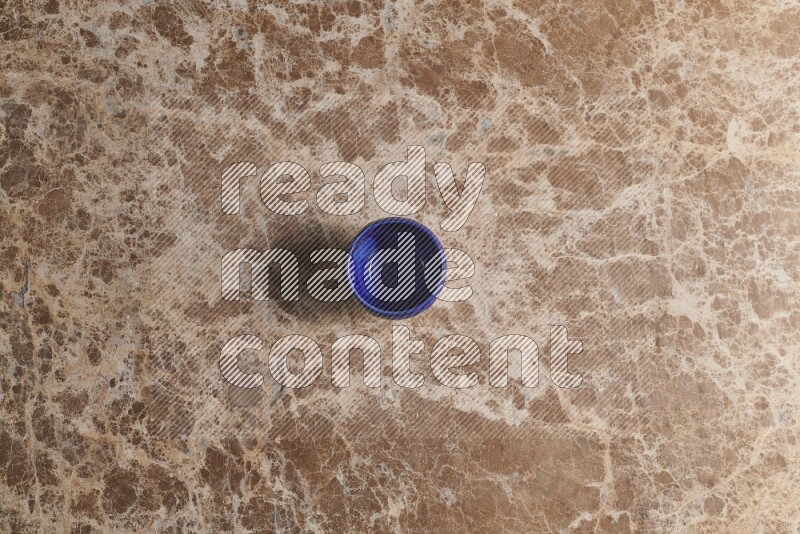 A pottery cup on beige marble background