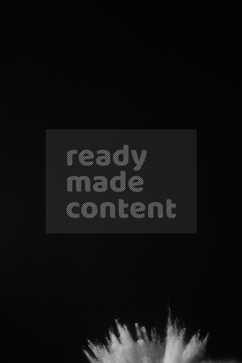 A side view of white powder explosion on black background