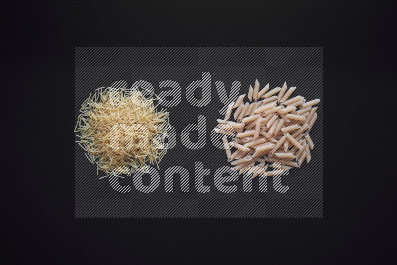 Different pasta types in bunches on black background